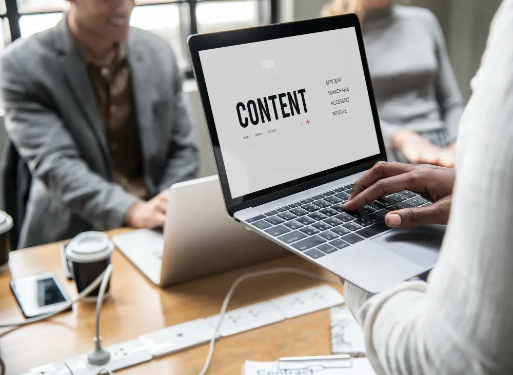 Content marketing team member works with laptop